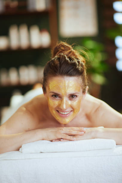 istock smiling modern woman in spa salon laying on massage table 2147572018