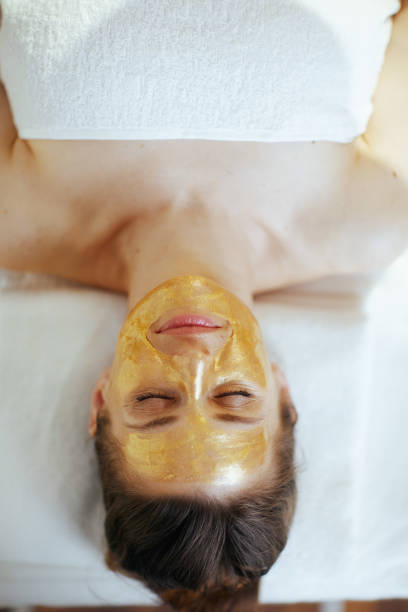 istock relaxed modern woman in massage cabinet laying on massage table 2147572020