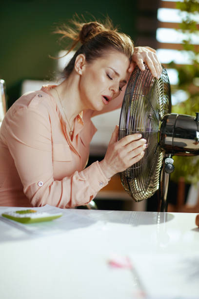istock modern business woman at work suffering from summer heat 2147573132