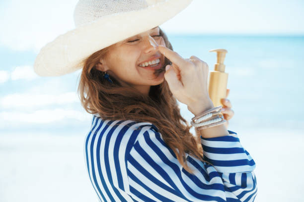 istock happy modern female on beach with sunscreen 2147575059