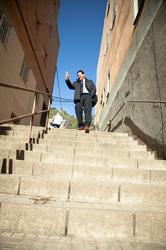 Businessman on the way to work, going down stairs