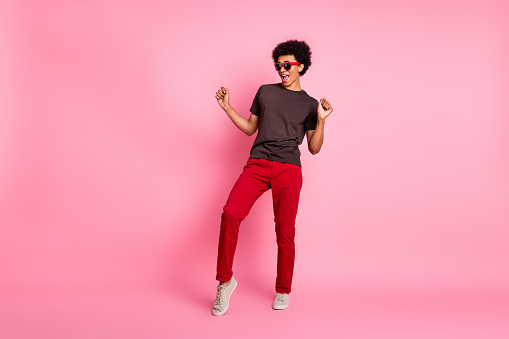 Full body size photo of cool student young guy in casual apparel sunglass night club discotheque isolated on pink color background.