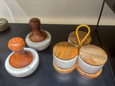 A wooden tray with three small bowls on it closeup