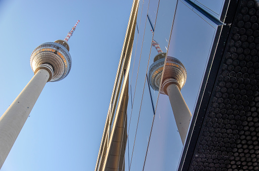 Berlin, Germany, March 8, 2024: the iconic Fernsehturm (television tower) reflects in the facade of an adjacent building on Alexanderplatz