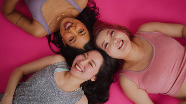 Diverse fashion models working and posing for camera in studio environment