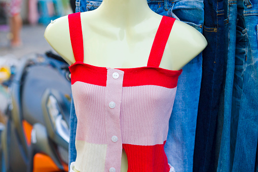 Ventriloquist's dummy with tank top at street fashion market stall in residential district of Bangkok Chatuchak