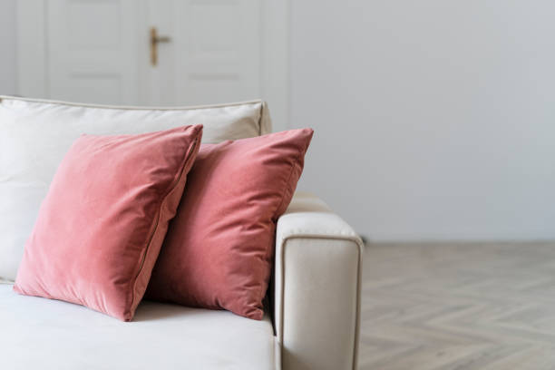 Closeup on comfort sofa with soft decorative cushions in living room Closeup on comfort sofa with soft decorative cushions in living room. Modern couch for relax at cozy home. Restoration furniture concept. Dry cleaning service couch arm rest stock pictures, royalty-free photos & images
