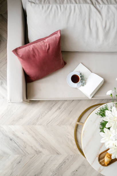 istock Top view on comfort couch with soft pillow, open notebook and cup of tea 2147581940