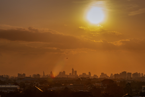 Sun of day at city of Bangkok with  building silhouette