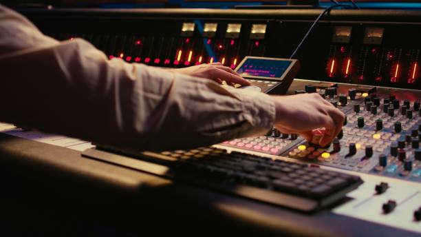 istock Sound designer working with sliders and switchers on control desk 2147582613