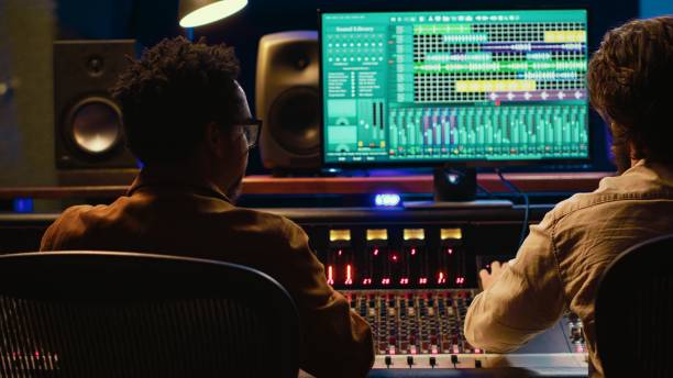 istock Diverse team collaborating on creating a new hit song in control room 2147582664