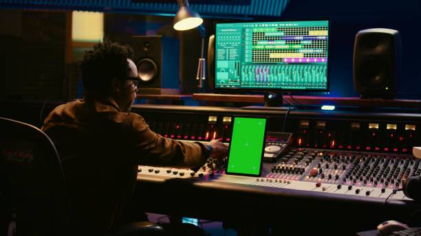 istock African american audio technician mixing and editing tracks with greenscreen 2147582753