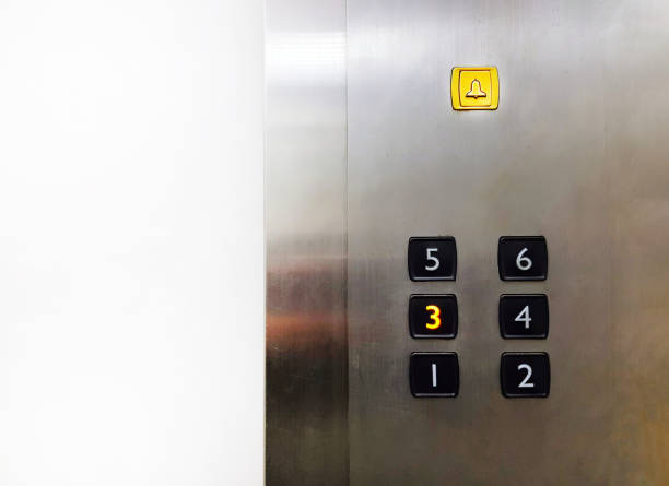 istock Group of Black Elevator push buttons with yellow bell, warning or alarm buttons on stainless steel background with copy space that shows passenger pressed on third floor for going up or down. 2147582873