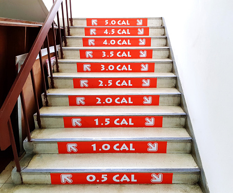 Orange number of waste calories when people going up and going down staircase. Healthy care and Exercise concept