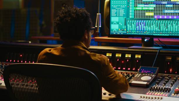 istock Audio expert counts down for artist singing in vocal booth, 2147583287