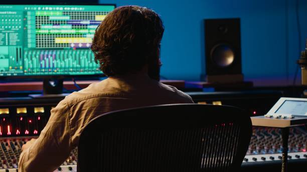 istock Audio technician working in control room to edit and process tracks 2147583611