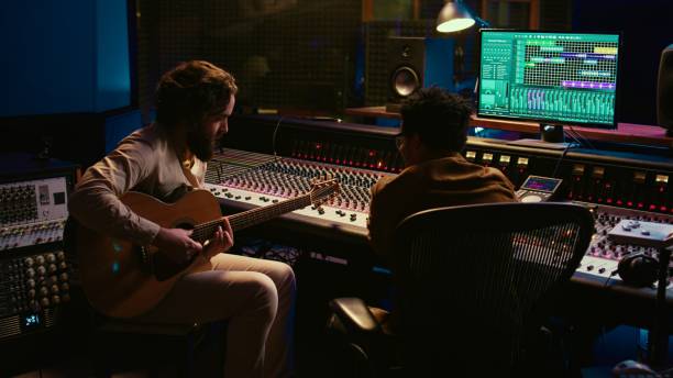 istock Talented artist doing live performance with his guitar in professional studio 2147584306