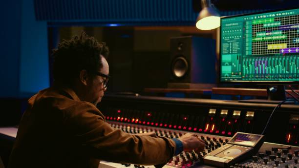 istock Sound designer uses mixing console and managing audio tracks 2147584369