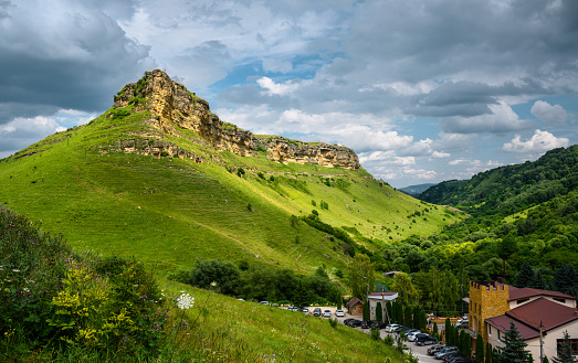 Mountain landscape at Honey Waterfalls canyon near Kislovodsk, Russia. View of scenic green forest and sky in Russian Kavkaz in summer. Concept of nature, travel, tourism in Caucasian Mineral Waters.