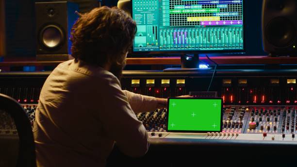 istock Audio technician working with music recording software and editing tunes 2147584600