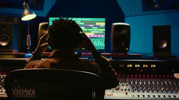 istock Professional tracking engineer using headphones to edit recorded tracks 2147584698