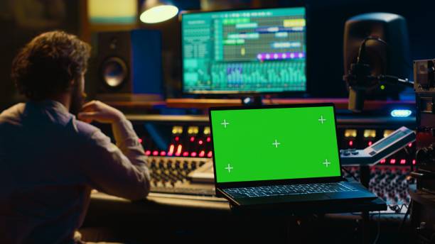 istock Audio technician leveling sound on recorder mixing console 2147585002