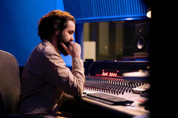 istock Sound engineer mixes individual tracks to create balanced music 2147585746