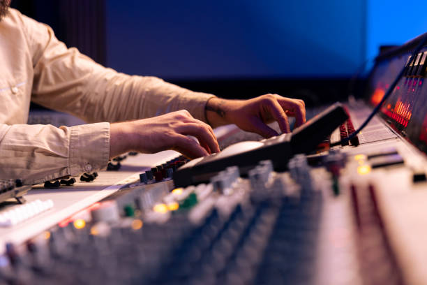 istock Audio expert uses mixing console and switchers on control room panel 2147585868