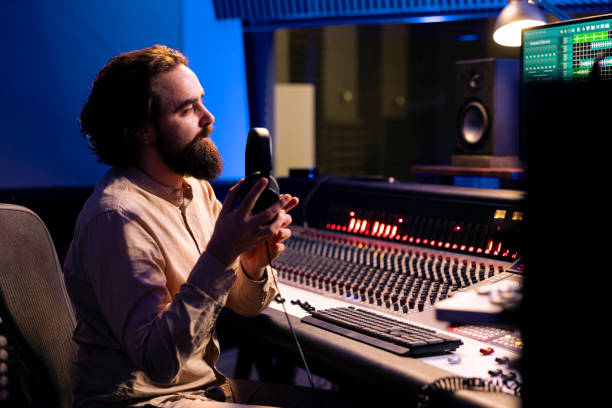 istock Sound designer working on track recording with technical gear in control room 2147585895