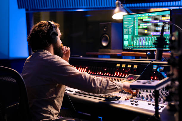 istock Audio expert operating on control desk with motorized faders and mixing console 2147585944