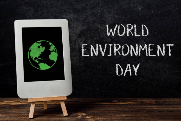 istock A white tablet with a green planet on it is on a wooden table 2147586336