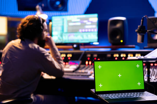 istock Male technician working on editing tracks next to greenscreen 2147586448