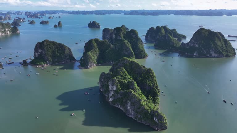 Aerial Drone Sunset Scene of Rock Mountain on the sea at Ha Long bay with ha Long City, North of Vietnam