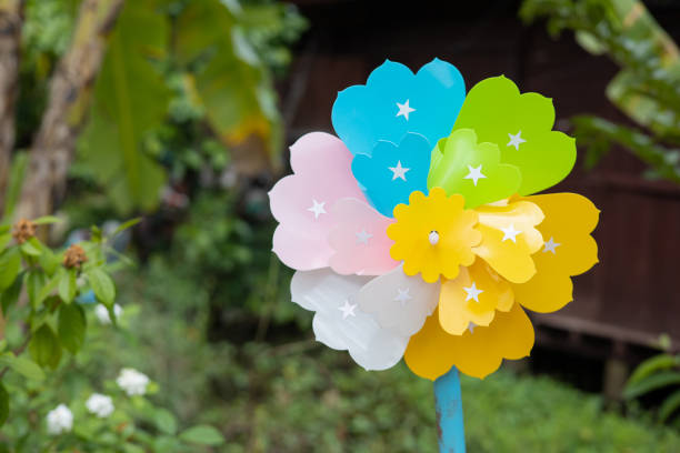 Rainbow pinwheel toy spinning in the backyard.