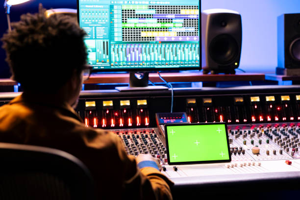 istock African american audio engineer looks at greenscreen and editing software 2147587316