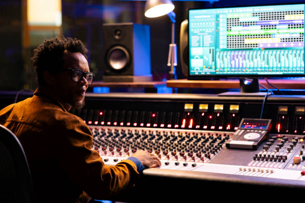 istock Sound designer working on control desk in professional studio 2147587333