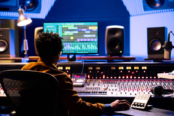 istock Music producer editing and processing sounds in control room 2147587477