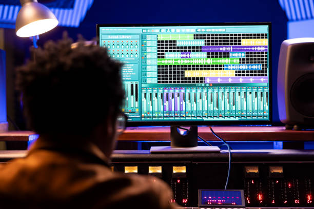 istock African american sound engineer recording music and working with audio software 2147587555
