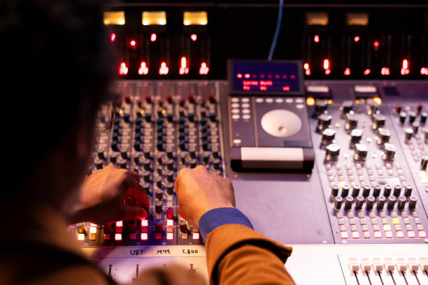 istock African american audio technician pushing sliders and switchers on panel board 2147587577