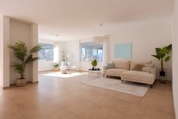 istock Spacious living room with carpet sofa and large open space in front. Large windows and green plants inside. 2147588969