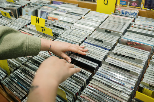 A woman searching between vinyl records