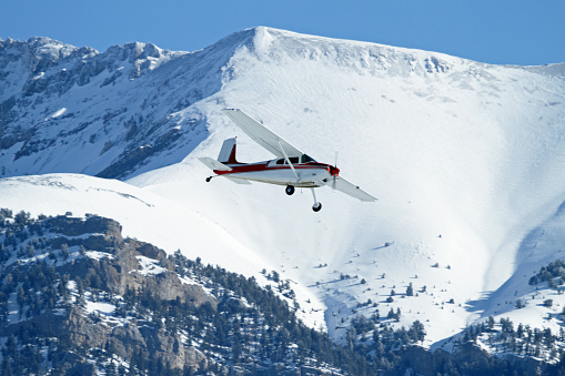 Cessna 180 flying through the Lost River Mountain Range of Eastern Idaho.