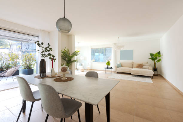 istock Large dining room and large living room. All in the same space.  Nice marble table with four chairs. Very warm and cosy space. 2147589352