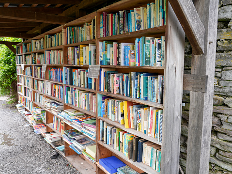 5th April 2024: Shelves of second hand books at an outdoor honesty bookshop, where people 
buy books and leave payment on a trust basis. Hay-on-Wye market town in Powys, South Wales. It is famous for its many book shops, selling old and new books, as well as hosting a popular annual literary festival.