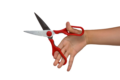 Close up image of a hand holding a red scissor with white background