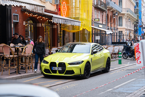 Toulouse, France - 29 March, 2024: A BMW M4 painted in a vivid green color, parked in a street of Toulouse