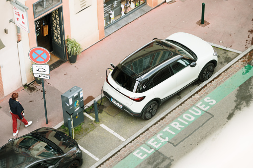 Toulouse, France - 29 March, 2024: A Smart #1 electric car charging in a city street as seen from above