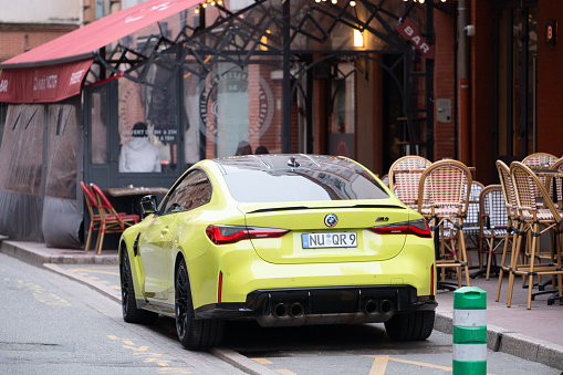 Toulouse, France - 29 March, 2024: A BMW M4 painted in a vivid green color, parked in a street of Toulouse