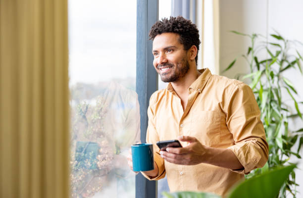 istock Businessman texting on his cell phone while taking a coffee break 2147591254