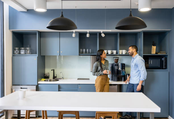 istock Coworkers talking in the cafeteria while taking a break at the office 2147591299
